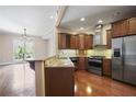 Modern kitchen with stainless steel appliances, wooden cabinets, granite countertops, and sleek backsplash, ideal for cooking at 326 Roswell Se St # 508, Marietta, GA 30060