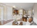 Open-concept living room with hardwood floors, view to kitchen, adjacent dining area at 326 Roswell Se St # 508, Marietta, GA 30060