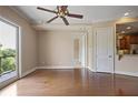 Elegant living room with hardwood floors, neutral decor, crown molding, and a sliding glass door to an outdoor balcony at 326 Roswell Se St # 508, Marietta, GA 30060