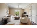 Cozy living room with hardwood floors, neutral paint, sliding glass door, and modern ceiling fan at 326 Roswell Se St # 508, Marietta, GA 30060