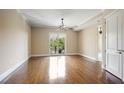 Bright and airy living room with hardwood floors, neutral walls, and a sliding glass door that leads to a balcony at 326 Roswell Se St # 508, Marietta, GA 30060