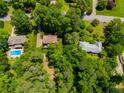 Aerial view of a neighborhood showing home, pool, and mature trees at 9041 Par Dr, Douglasville, GA 30134