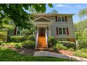 Two-story home with brick stairs, white railings, and landscaped front yard at 9041 Par Dr, Douglasville, GA 30134