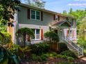 Well-maintained two-story home with lush green landscaping in front at 9041 Par Dr, Douglasville, GA 30134