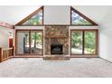 Living room featuring a stone fireplace and large windows at 1909 Winding Creek Sw Ln, Marietta, GA 30064