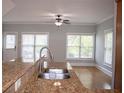 Bright kitchen area with a stainless steel faucet, sink, and view into the living space at 625 Chestnut St # D, Atlanta, GA 30354