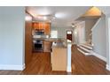 Well-lit kitchen featuring granite countertops, stainless steel appliances, and wood flooring at 625 Chestnut St # D, Atlanta, GA 30354