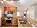 Close-up of a kitchen with granite counters, stainless steel appliances, and wood cabinetry at 625 Chestnut St # D, Atlanta, GA 30354