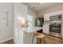 Kitchen features breakfast bar with seating, stainless steel oven and microwave at 9155 Nesbit Ferry Rd # 65, Alpharetta, GA 30022