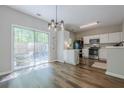 Open kitchen and dining area with stainless steel appliances and granite countertops at 9155 Nesbit Ferry Rd # 65, Alpharetta, GA 30022