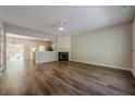 Bright living room featuring a fireplace, ceiling fan and wood floors at 9155 Nesbit Ferry Rd # 65, Alpharetta, GA 30022