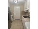 The kitchen has a stainless steel refrigerator, white appliances and ample countertop space at 4701 Flat Shoals Rd # 41-F, Union City, GA 30291