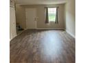 Living room with wood laminate flooring, a window, and neutral walls at 4701 Flat Shoals Rd # 41-F, Union City, GA 30291