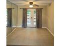 Living room featuring tile floors, French doors, and a ceiling fan with light at 4701 Flat Shoals Rd # 41-F, Union City, GA 30291
