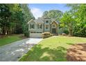 Charming two-story home featuring a well-manicured lawn and inviting curb appeal at 7635 Wynfield Dr, Cumming, GA 30040