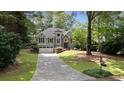 Charming two-story home featuring a well-manicured lawn and inviting curb appeal at 7635 Wynfield Dr, Cumming, GA 30040