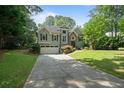 Charming two-story home featuring a well-manicured lawn and inviting curb appeal at 7635 Wynfield Dr, Cumming, GA 30040