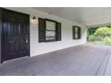 Charming front porch features fresh paint, black shutters, and ample space for outdoor seating at 1353 Litchfield Ct, Snellville, GA 30078