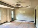 Spacious room featuring a tray ceiling and ample natural light from the window at 678 Sweet Ashley Way, Loganville, GA 30052