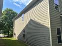 Side view of home with siding, windows, and a view of the grassy yard at 678 Sweet Ashley Way, Loganville, GA 30052
