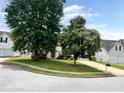 Residential street featuring well-maintained lawns, mature trees, and a view of the homes at 130 Hazelhurst Dr, Covington, GA 30016