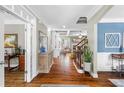Elegant foyer with hardwood floors, decorative columns, and staircase, creating a welcoming and sophisticated entry at 4840 Spring Park Cir, Suwanee, GA 30024
