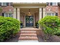 Close up on the double front doors with brick steps and flanking bushes at 4840 Spring Park Cir, Suwanee, GA 30024