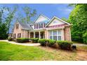 Charming two-story brick home featuring manicured landscaping and classic architectural details at 5995 Azalea Ridge Dr, Douglasville, GA 30135