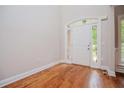Bright foyer with hardwood flooring and a white front door featuring glass panes at 5995 Azalea Ridge Dr, Douglasville, GA 30135
