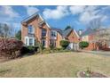 Charming two-story brick home featuring an attached two-car garage, driveway and landscaping at , Suwanee, GA 30024