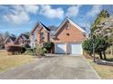 Charming two-story brick home featuring an attached two-car garage, long driveway and landscaping at , Suwanee, GA 30024