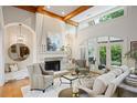 Elegant living room with high ceilings, exposed beams, a fireplace, and large windows for natural light at 5119 Greythorne Ln, Marietta, GA 30068