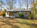 Inviting home exterior featuring a cozy porch, lush landscaping, and a well-maintained lawn at 1377 Dorothy Dr, Decatur, GA 30030