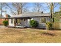 View of the home's exterior featuring a cozy front porch and manicured landscaping at 1377 Dorothy Dr, Decatur, GA 30030