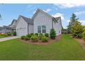 Well-maintained single-story home with a two-car garage, a long driveway, and lush landscaping at 5320 Coltman Dr, Cumming, GA 30028