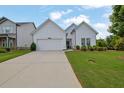 Traditional single-story home featuring a well-manicured lawn and a wide concrete driveway at 5320 Coltman Dr, Cumming, GA 30028