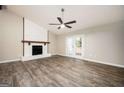 Spacious living room with fireplace, ceiling fan, and glass doors to the backyard at 5474 Post Road Pass, Stone Mountain, GA 30088