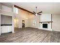 Open living space featuring a fireplace, beam, bar and modern wood flooring at 5474 Post Road Pass, Stone Mountain, GA 30088