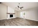 Bright living room featuring a painted fireplace, ceiling fan and double doors leading to outdoor at 5474 Post Road Pass, Stone Mountain, GA 30088