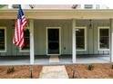 Welcoming front porch with classic pillars and an American flag, a perfect outdoor space at 60 Valley Rd, Covington, GA 30016