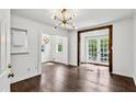 Bright living room showcasing hardwood floors, stylish lighting, and an inviting transition to an outdoor view at 1072 Piedmont Ne Ave # 101, Atlanta, GA 30309