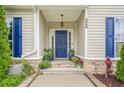 Inviting entryway with blue front door, stone accents, and well-kept landscaping, offering a warm welcome at 188 Cooper Creek Dr, Dallas, GA 30157