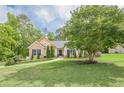 Spacious front yard with mature tree and well-maintained lawn, showcasing the home's curb appeal and serene setting at 188 Cooper Creek Dr, Dallas, GA 30157