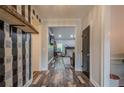 Stylish hallway featuring unique accent wall, wood-look floors, and views into the adjacent living space at 188 Cooper Creek Dr, Dallas, GA 30157