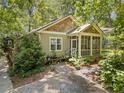 Attractive home exterior with a screened porch and lush landscaping in a wooded setting at 4649 Dahlia Dr, Pine Lake, GA 30072