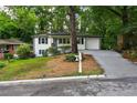 Charming white one-story home with landscaped front yard and inviting curb appeal at 163 Oakcliff Ct, South Fulton, GA 30331