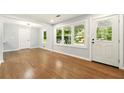 Bright and airy living room featuring hardwood floors and ample natural light from large windows at 163 Oakcliff Ct, South Fulton, GA 30331