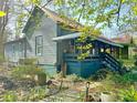 Charming home exterior featuring a covered porch, mature landscaping, and a tranquil setting at 23 Gould Se St, Atlanta, GA 30315