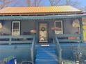Inviting home showcasing a cozy front porch, blue stairs, and charming decor, offering a warm welcome at 23 Gould Se St, Atlanta, GA 30315