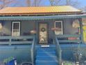 Inviting home exterior with a charming front porch, blue steps, and a tranquil curb appeal at 23 Gould Se St, Atlanta, GA 30315